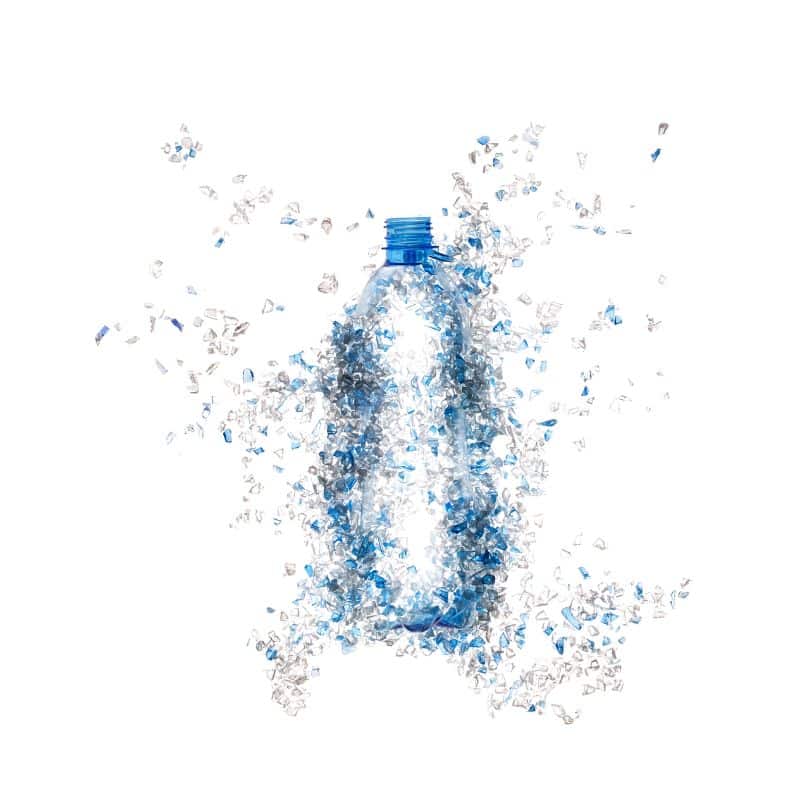 Plastic bottle disintegrating into PET pieces highlighting plastic bottle recycling.