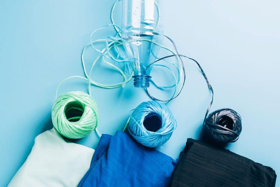 Setup showing plastic bottles transitioning to textile fibers, emphasizing polyester recycling.